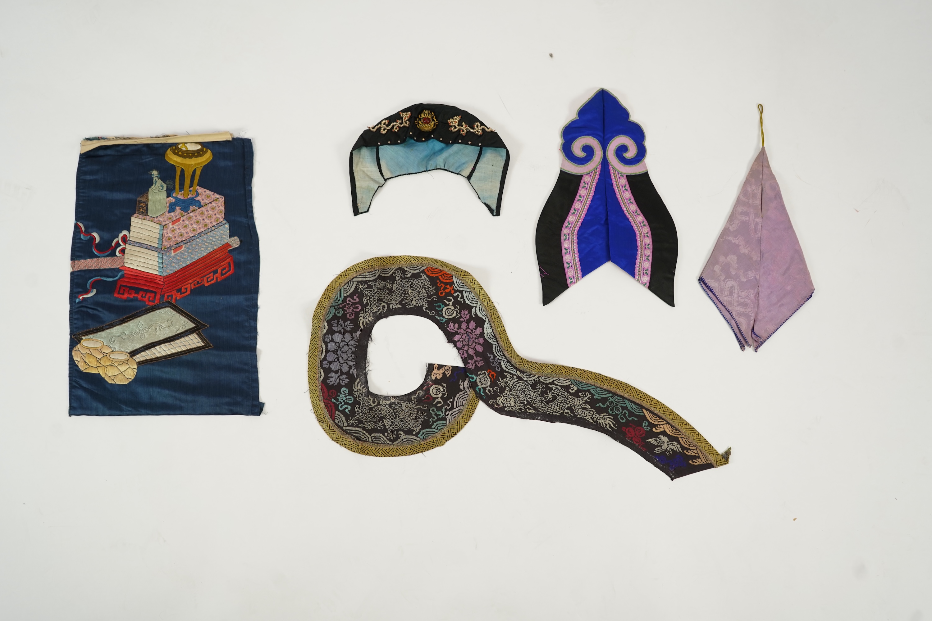 Two Chinese embroidered silk wedding skirts, late Qing, five hats, trousers, two skirt panels and two others, collar and a panel